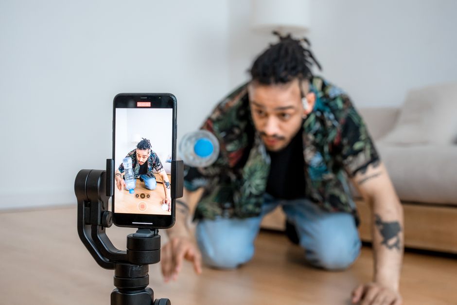 A creator filming a vertical short-form video on a smartphone gimbal for YouTube Shorts